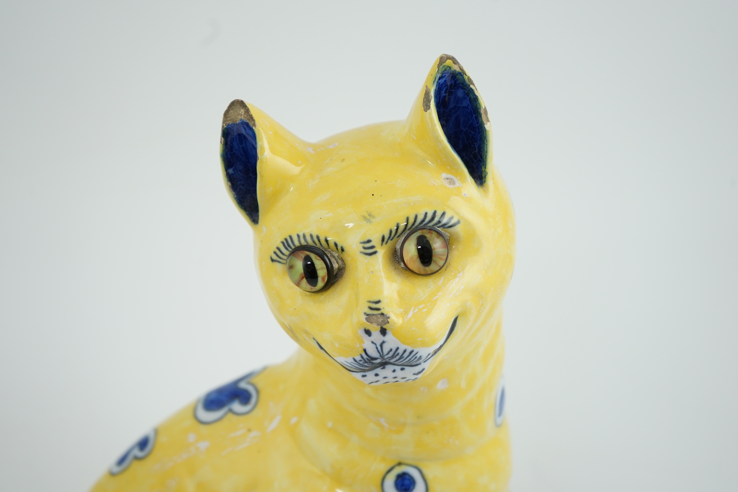 A Gallé yellow faience model of a seated smiling cat, c.1885